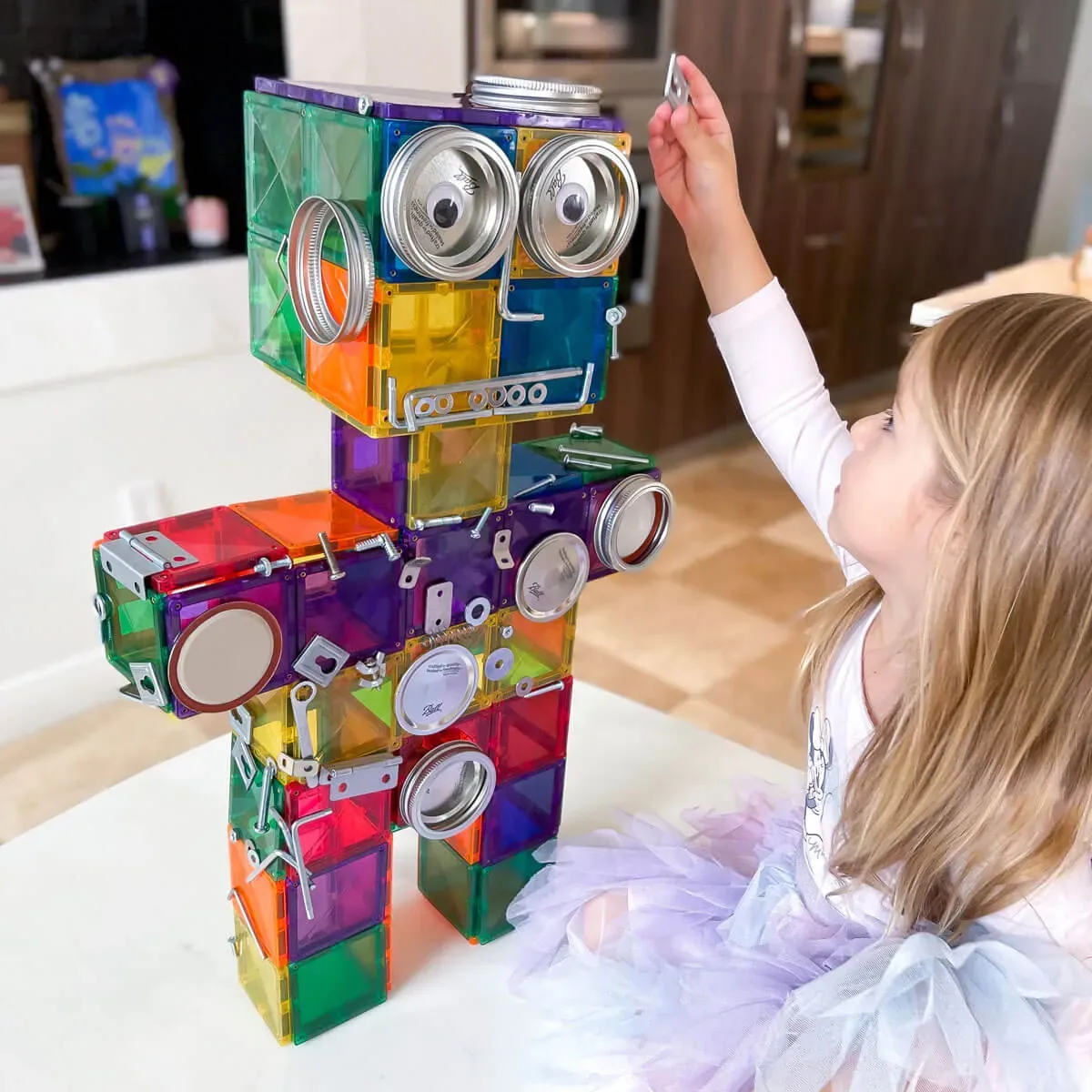 a girl is playing magnetic tile toy